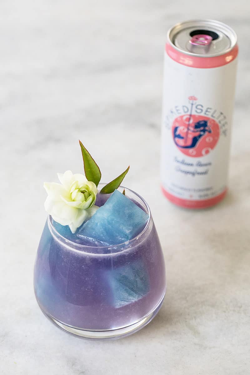 Purple Paloma cocktail with natural blue ice cubes topped with Bon & Viv Spiked Seltzer 