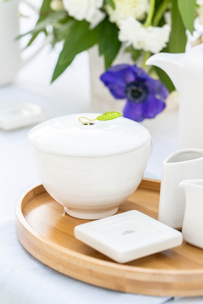 White tea cup on bamboo plate 