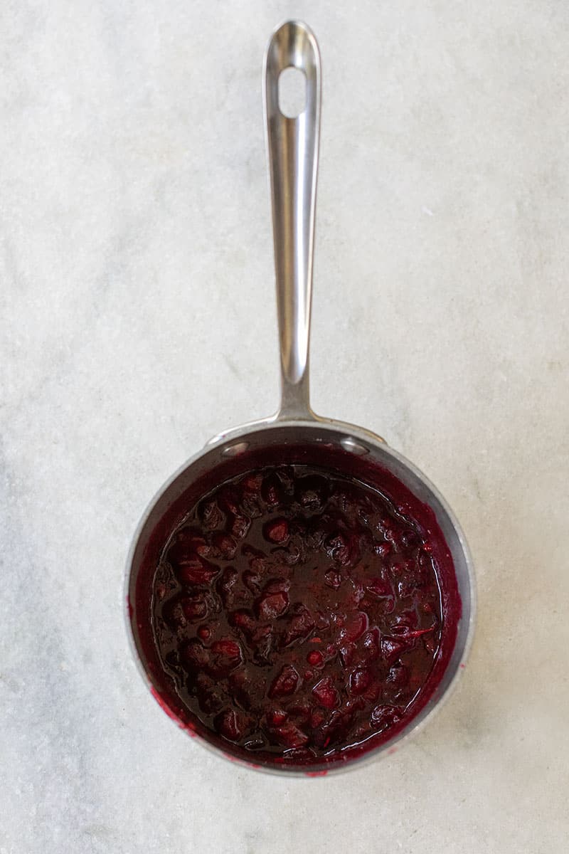 Boiled cranberries in medium pot after cooking. 