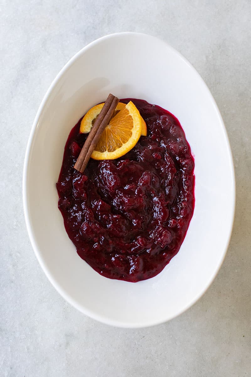 homemade cranberry sauce with orange juice served in a white bowl.