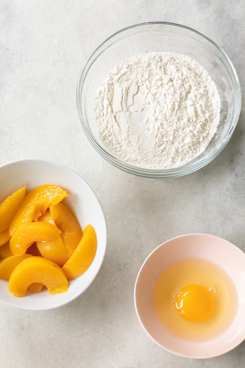 Ingredients to make a peach cake. 