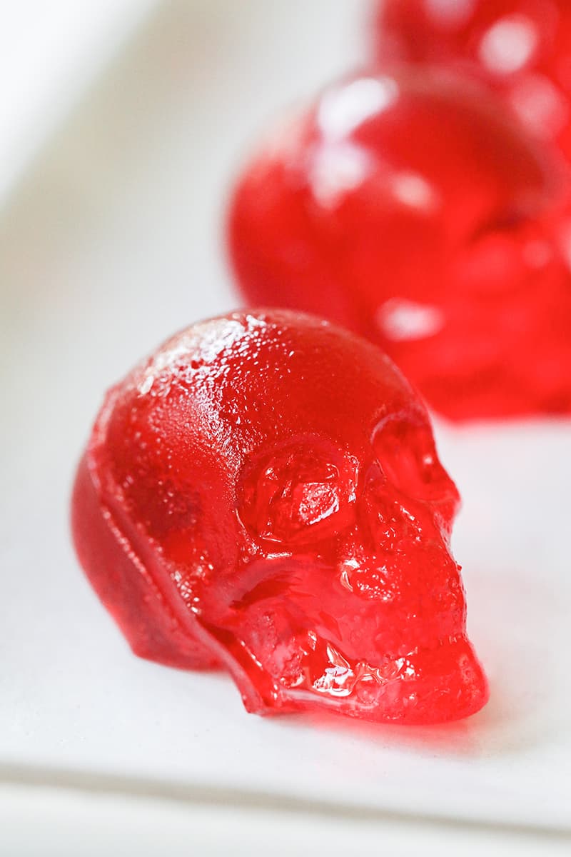 Red skull jello shot on a white plate for a Halloween Party