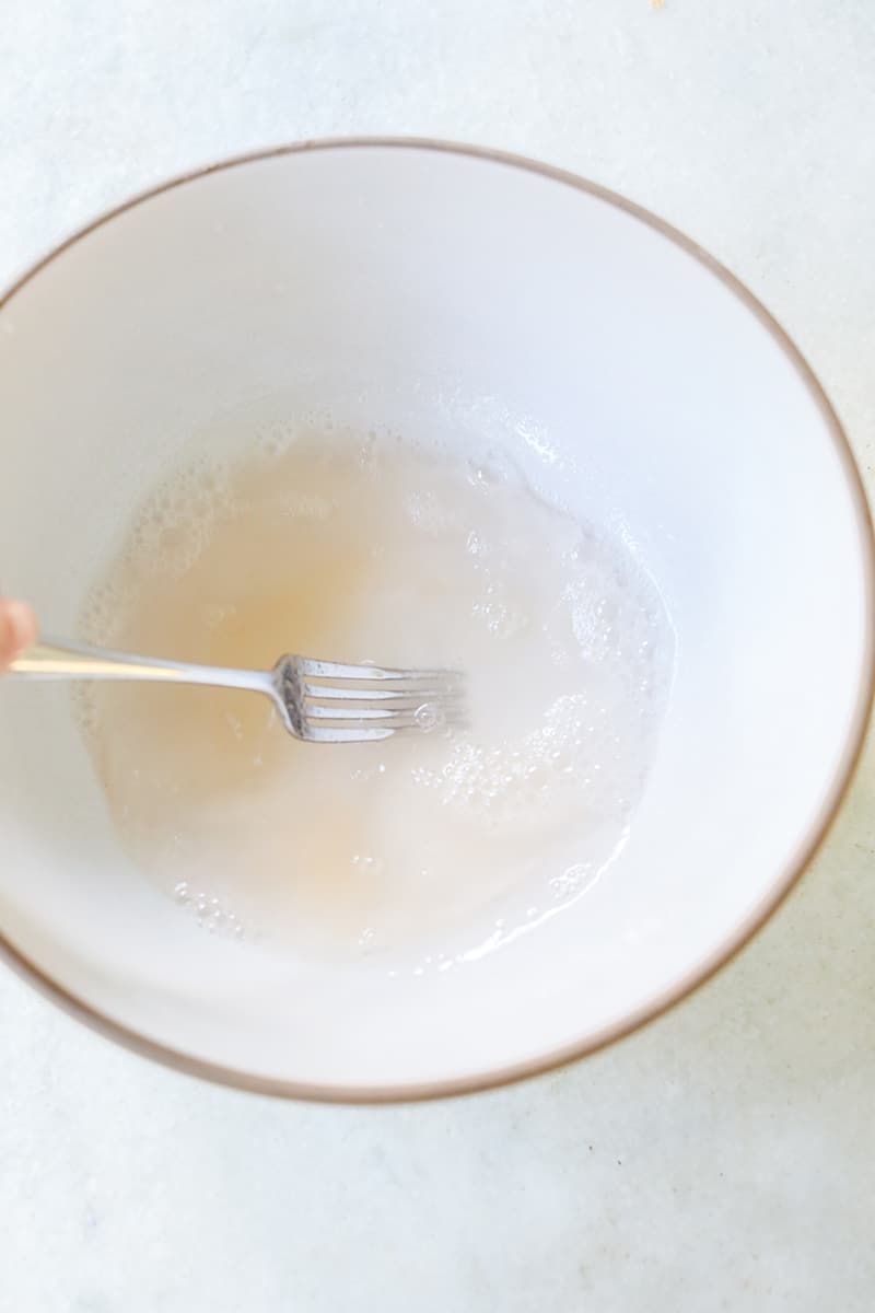 Whisking gelatin in with vodka for jello shot recipe