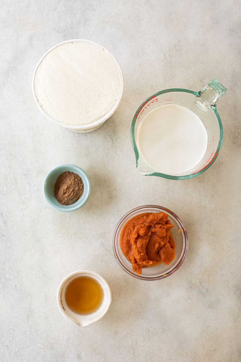 Ingredients to make a milkshake pumpkin flavor. - pumpkin pie shake