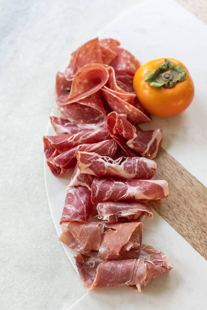 Rolled up charcuterie to make a Thanksgiving appetizer board.