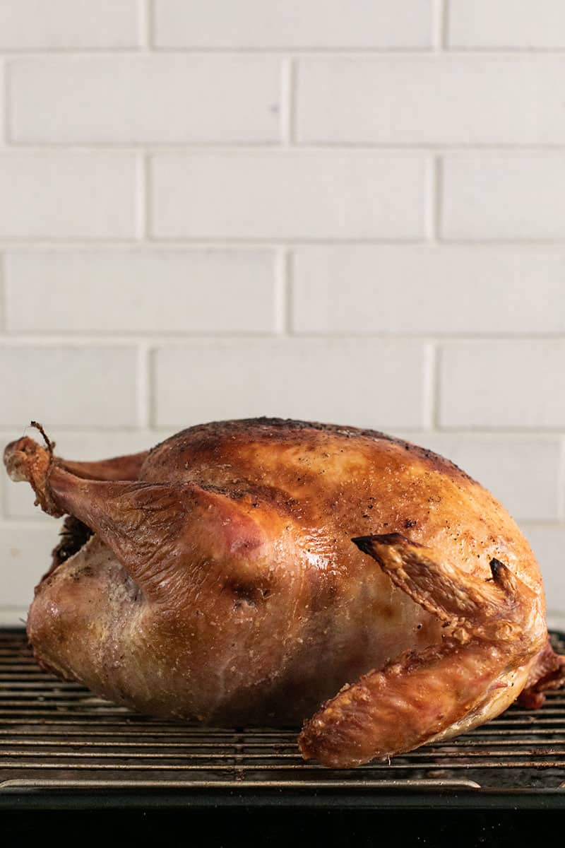 A beautifully browned turkey on a roasting rack. 
