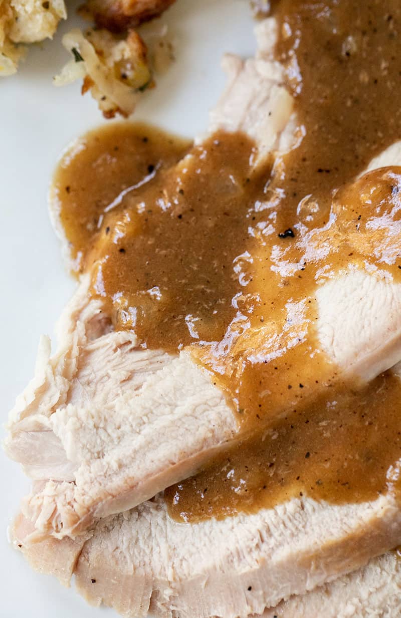 Sliced turkey breast with gravy.