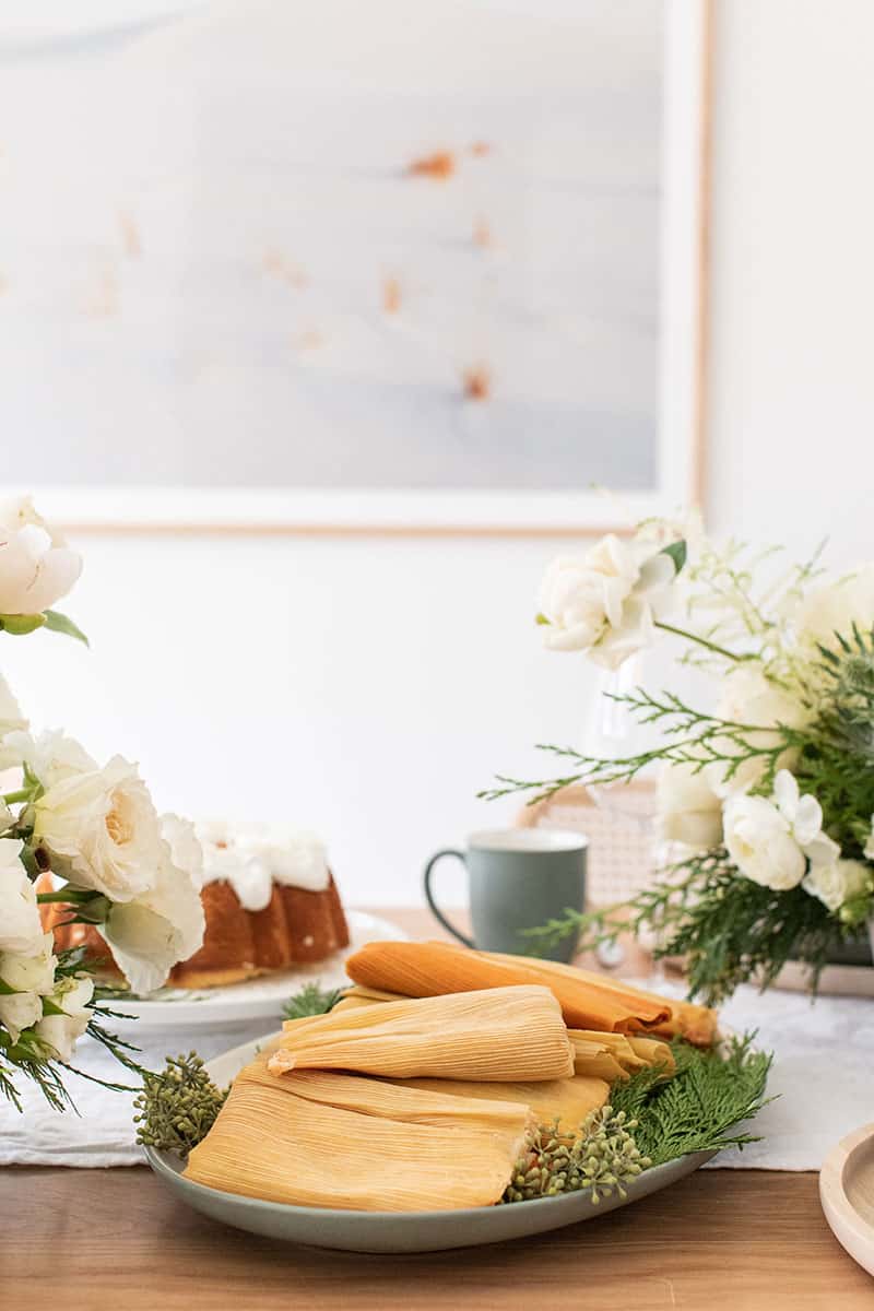 Christmas Eve Tamales on a table setting. - roast pork