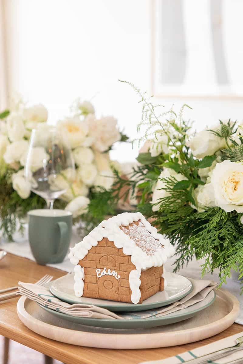 Table Setting with a gingerbread house. - christmas pudding, traditional christmas roast