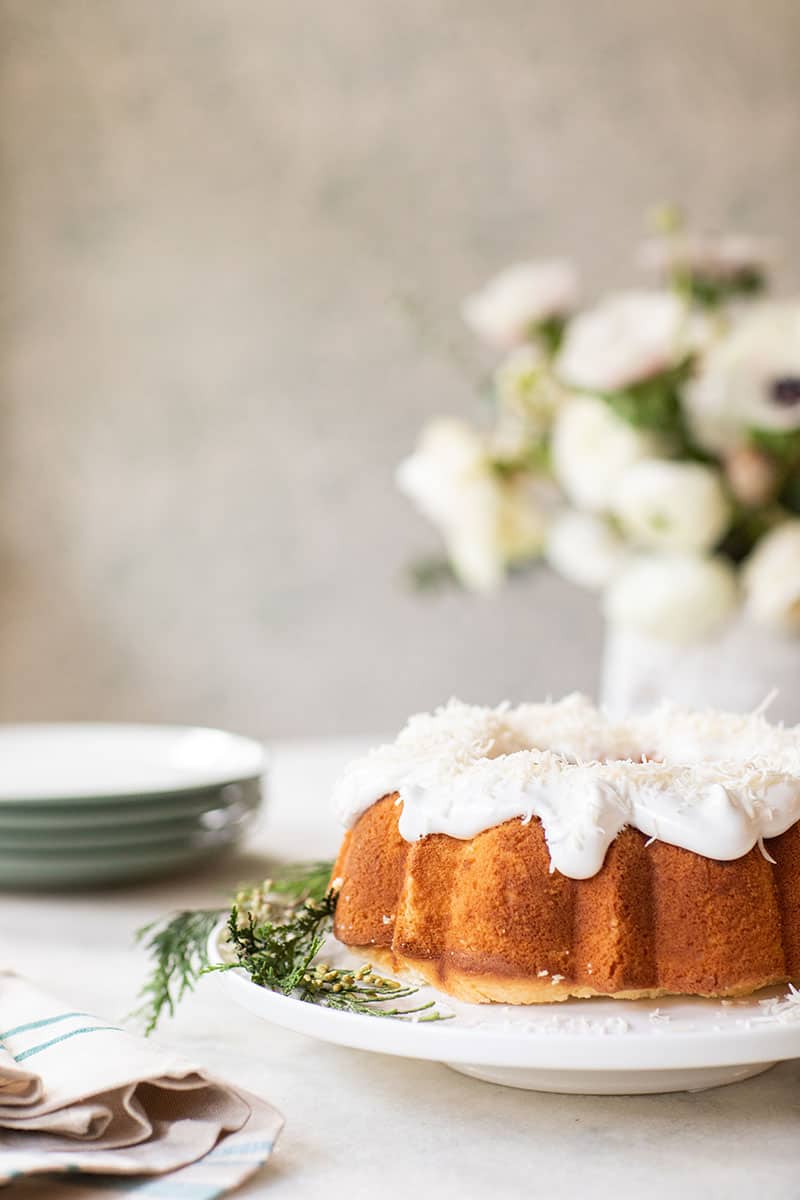 Classic southern coconut bunt cake on a footed cake stand. - christmas day, traditional dishes