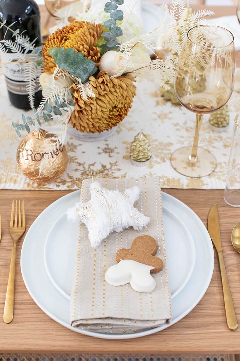 Christmas brunch table setting with flowers, napkins wine glasses.