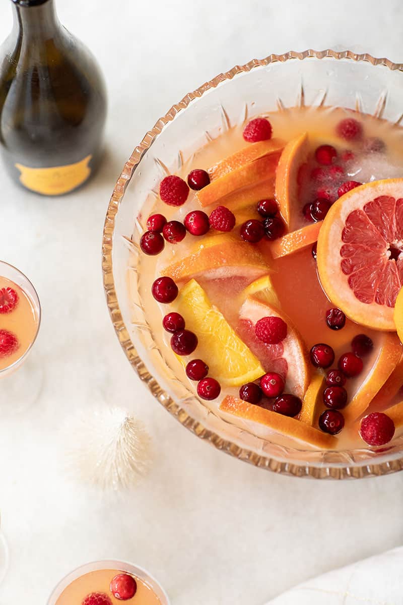 Citrus holiday punch with Prosecco, gin, oranges, grapefruit, cranberries and raspberries.