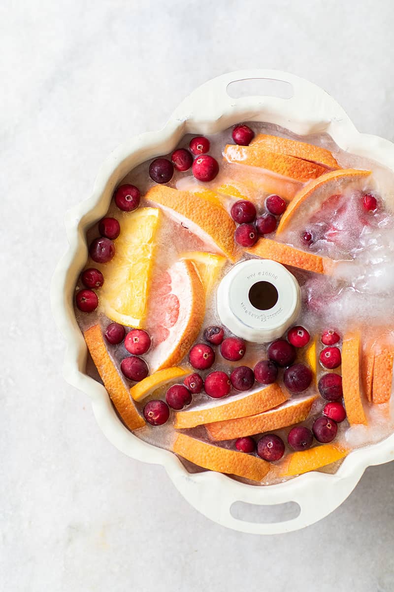 Sliced fruit in a bundt pan to make an ice ring for a cocktail.