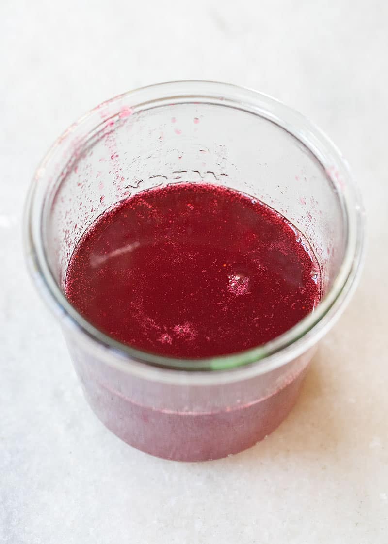 homemade cranberry simpel syrup in a glass jar