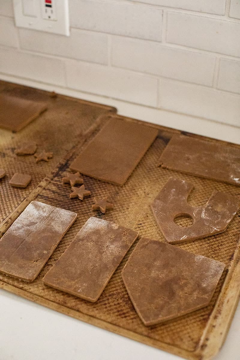 Gingerbread house on a baking sheet before it's baked.