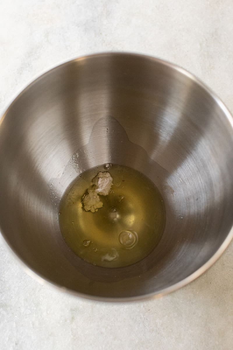 egg whites and cream of tartar in a metal bowl