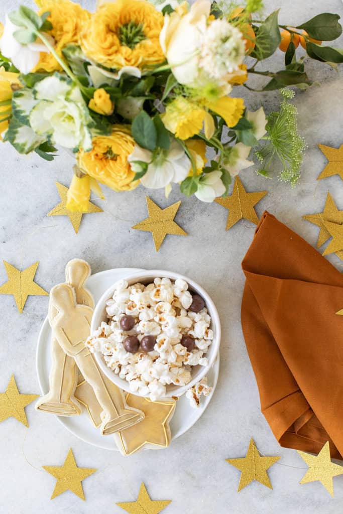 Popcorn with chocolate and Oscar cookies with gold stars.