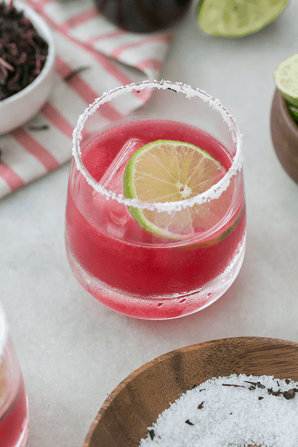 Hibiscus hot pink margarita with lime wedge and salted rim. 