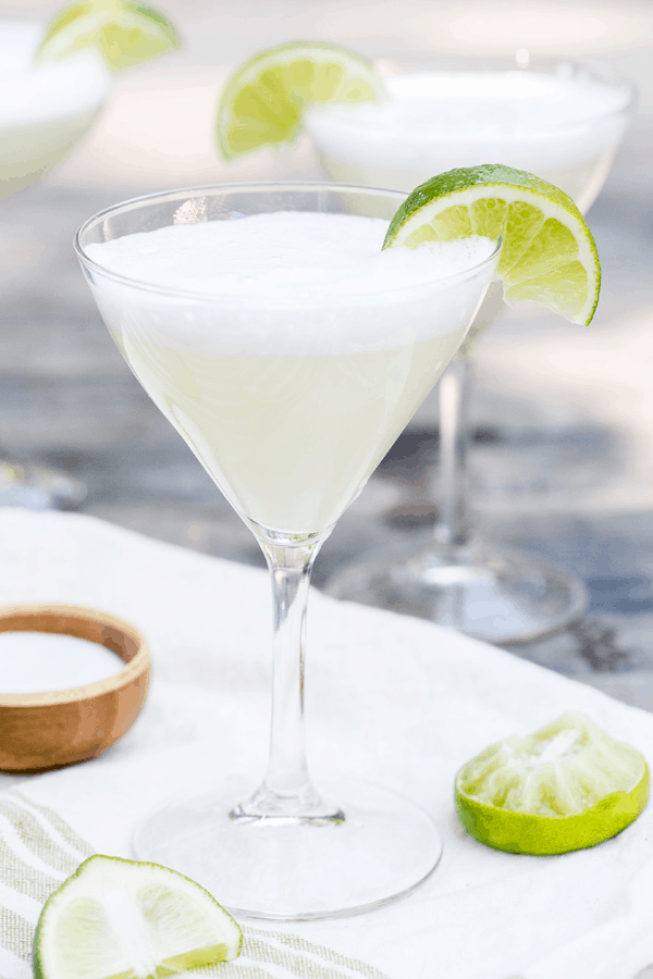 Salt air margarita in a martini cup with a lime wedge.