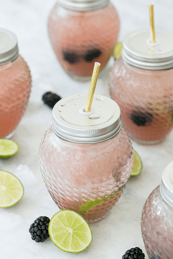 blackberry margarita recipe in a glass with fitted lid.