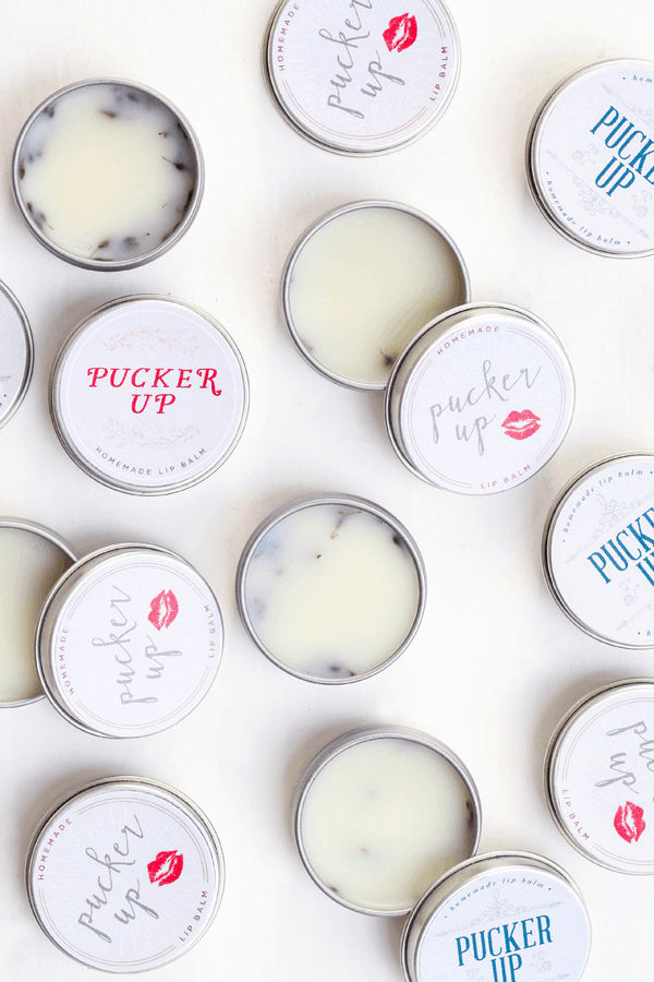 DIY lavender lip balm in tins with Valentine's Day labels. 