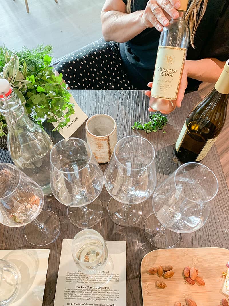 Herb and Wine tasting at Paradise Ridge Winery. Table full of glasses.