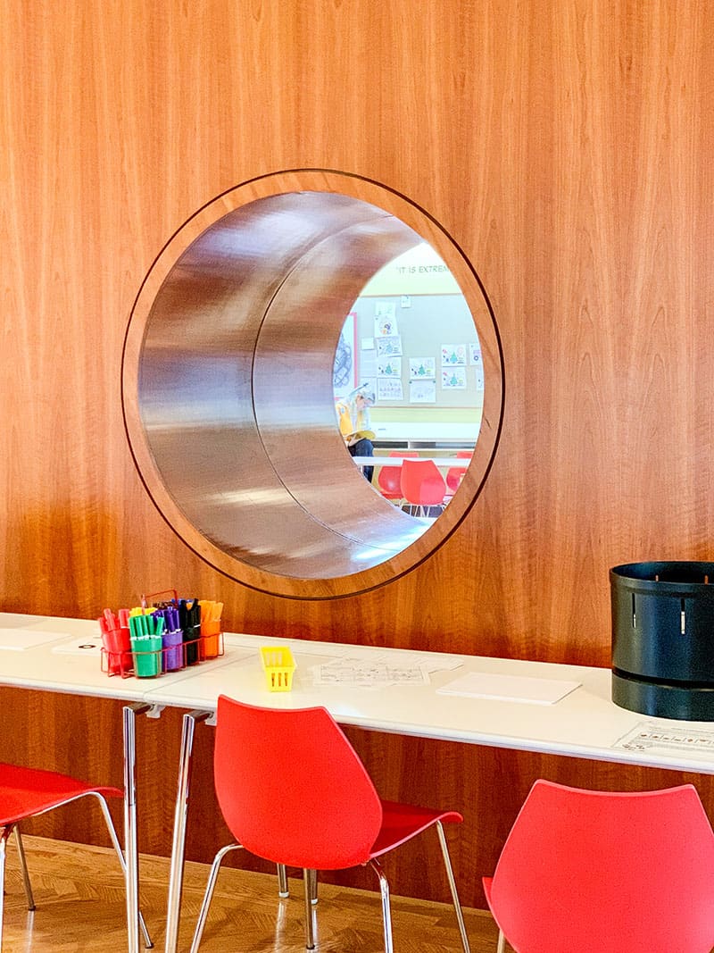 Wall with round window into kid education center