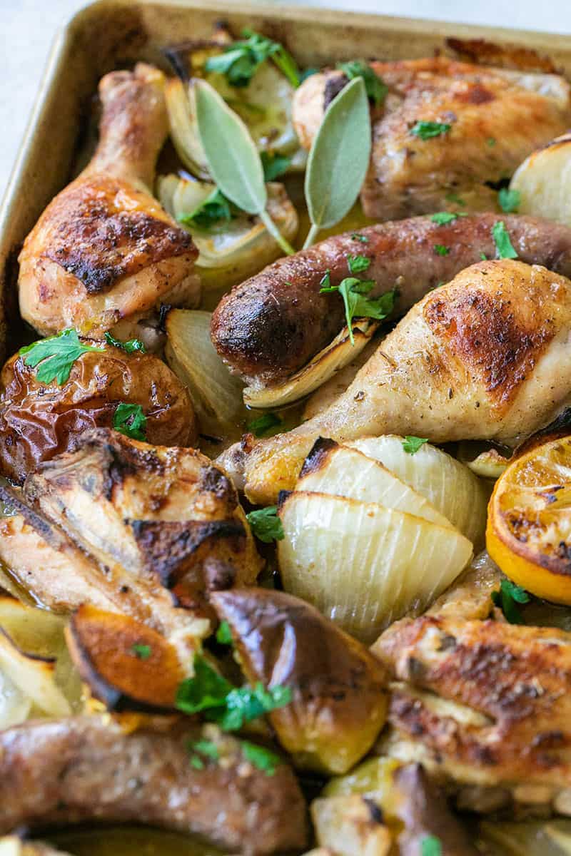 One-Pan Chicken and Sausage Bake with fresh sage, parsley, onions, lemons, apples and more seasonings. 
