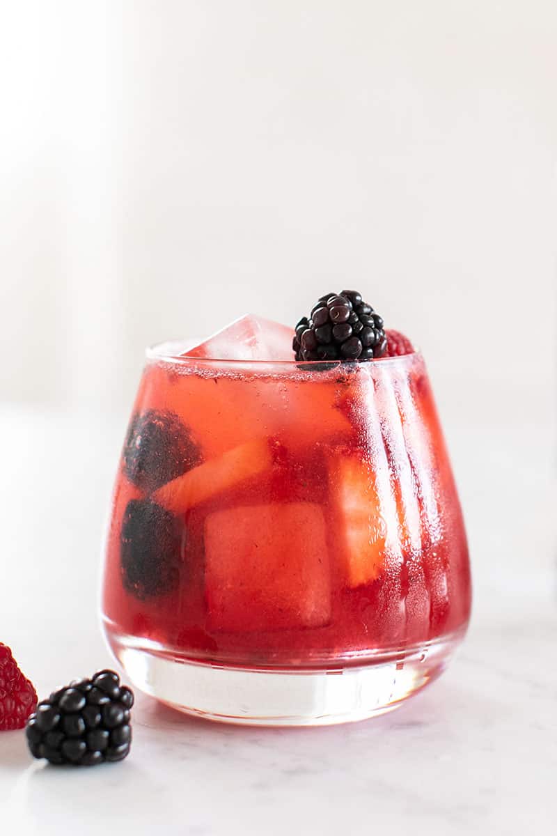 Wild Berry cocktail with strawberries, blackberries, raspberries and engird water. 