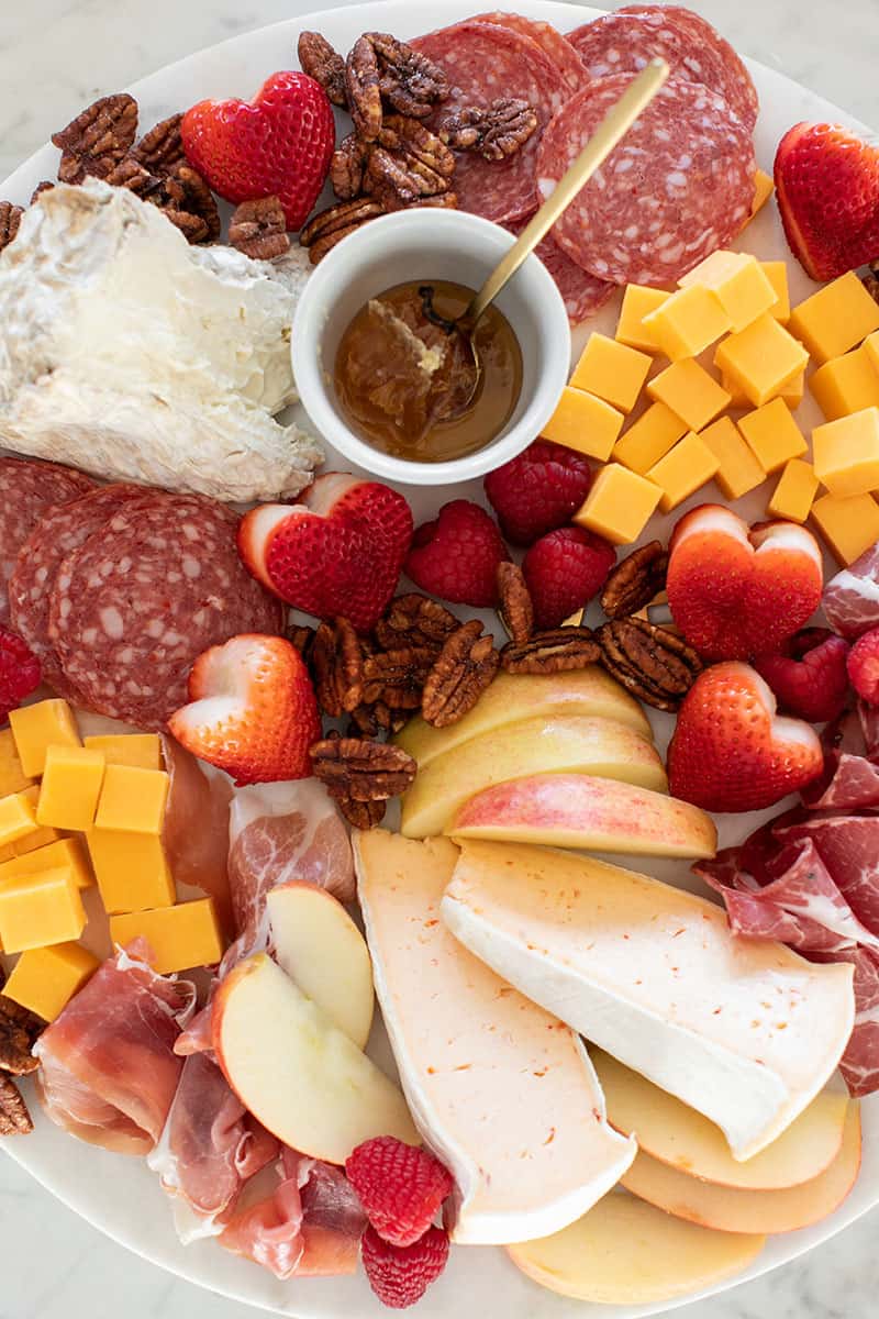 Meat and cheese on a marble platter.