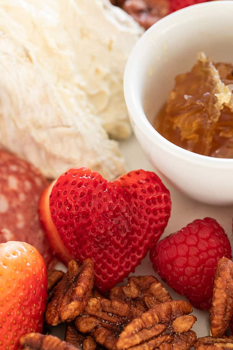 Juicy plump strawberries in the shape of a heart.