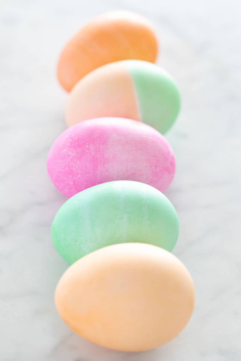 Colored Easter eggs in a row on a marble table. 