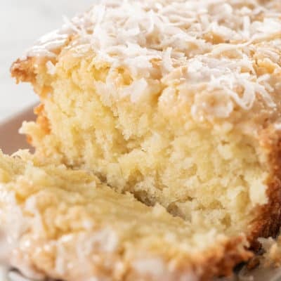 Coconut cake sliced with glaze.