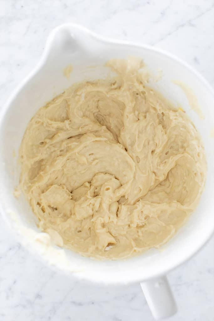 coconut cake batter in a white mixing bowl.
