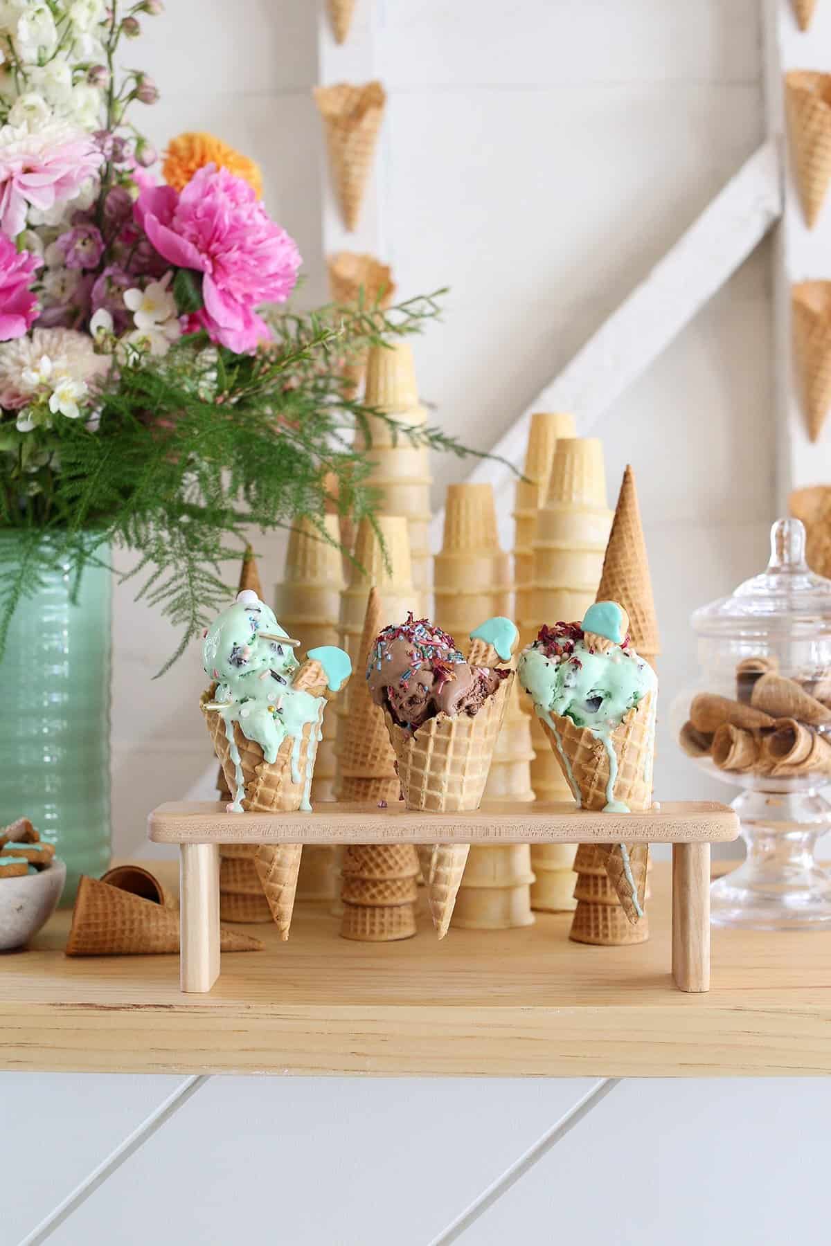 Ice cream bar with ice cream cones and colorful flowers.