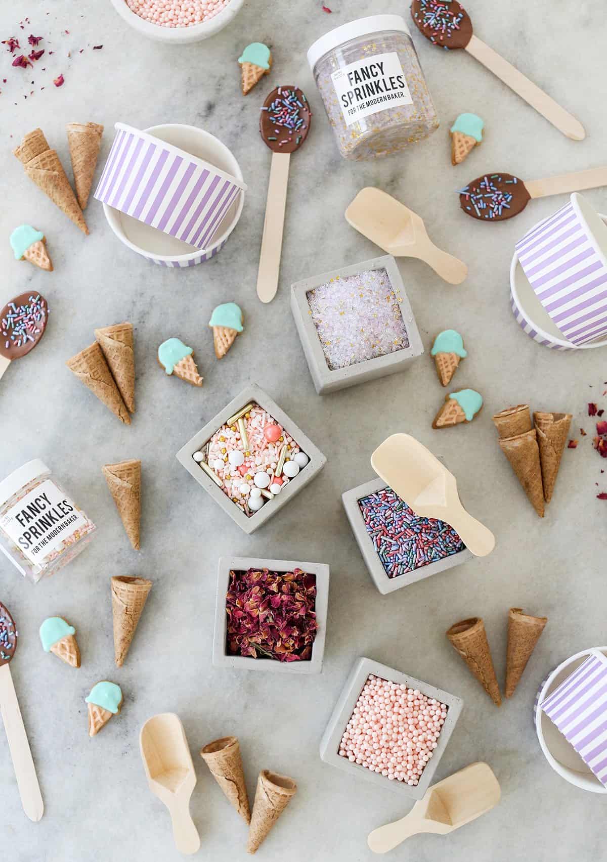 sprinkles, ice cream cones and dipped chocolate spoons for ice cream bar toppings