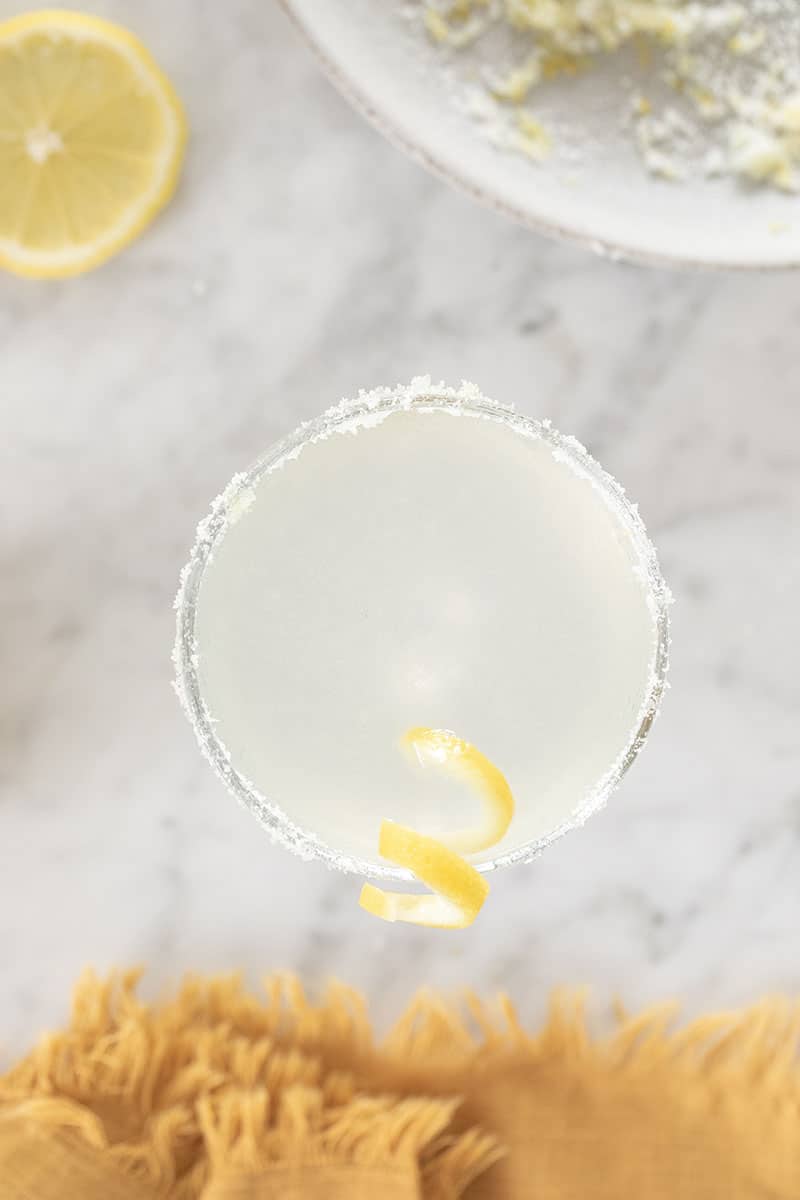 Lemon drop martini with lemon twist and sugared rim in a coupe glass.