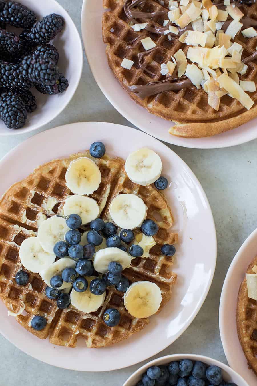 Blueberries and sliced banana waffles with syrup. 