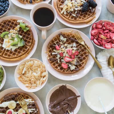 Waffle bar with waffles and toppings.