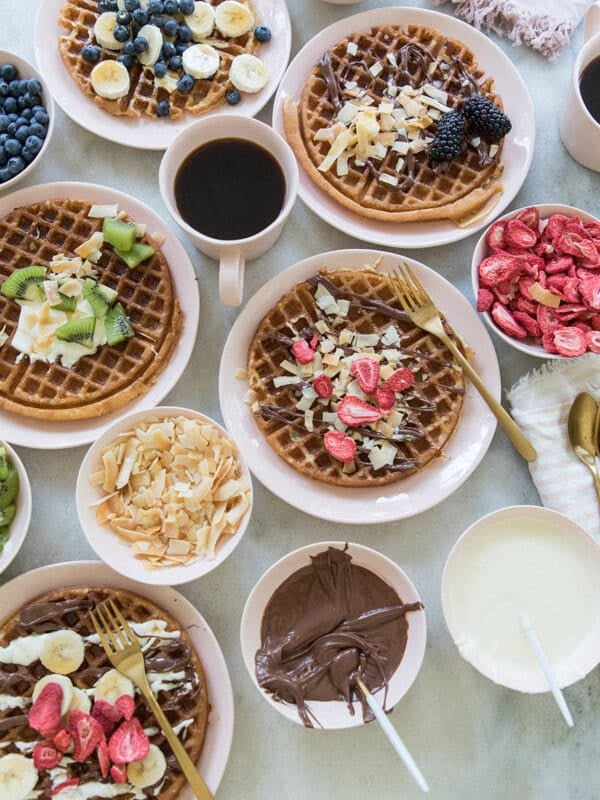 Waffle bar with waffles and toppings.