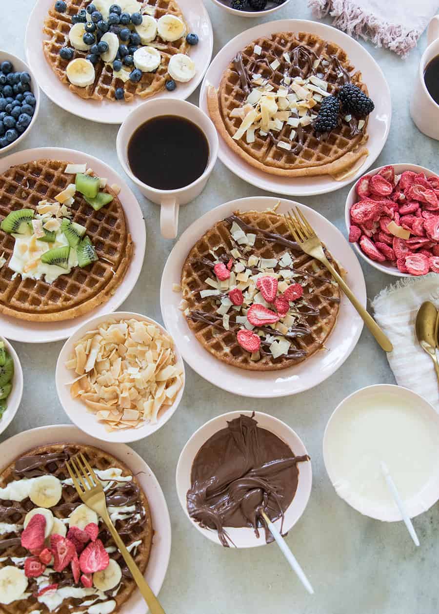 Waffle bar with waffles and toppings.