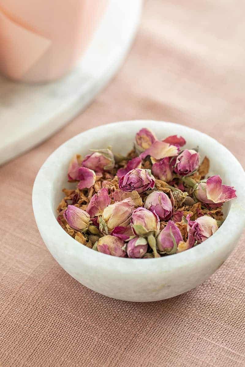 Dried rose petals in a marble bowl. 
