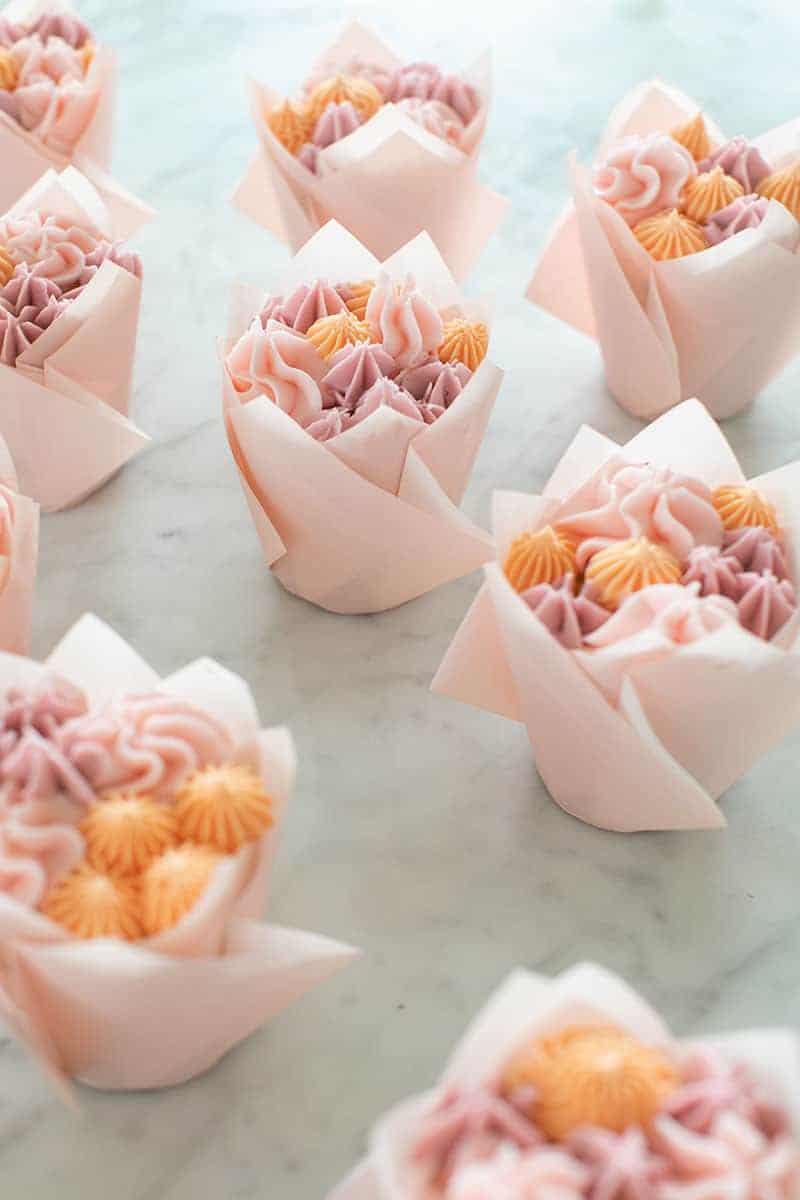 Floral cupcakes in pink tulip cupcake wrappers.