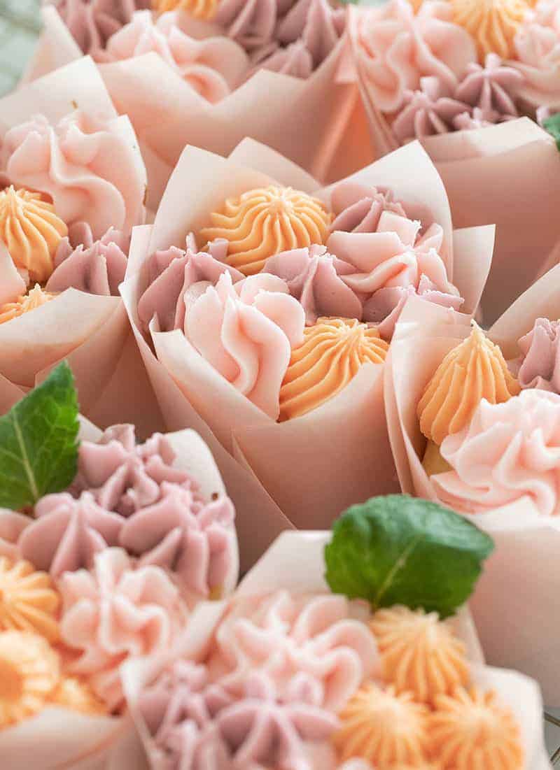 Flowers in a tulip cupcake wrapper with two little mint leaves.