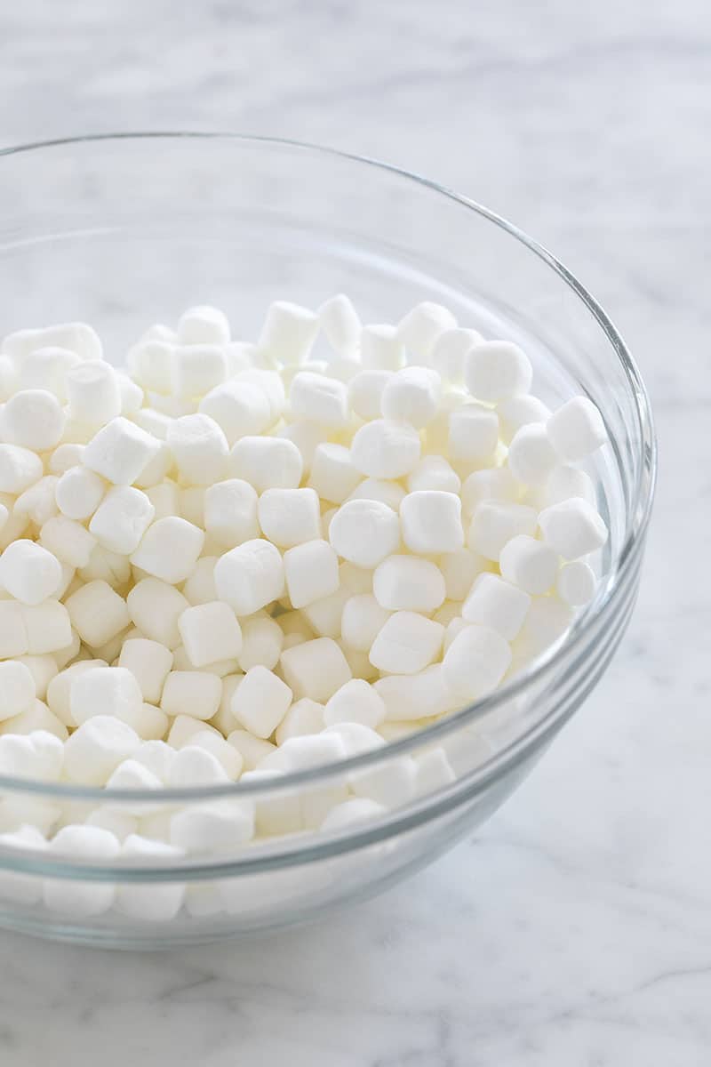 Mini marshmallows in a glass bowl.