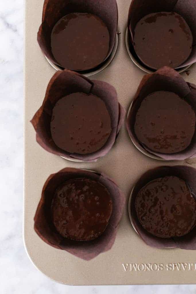 Chocolate cupcake batter in tulip cupcakes. 