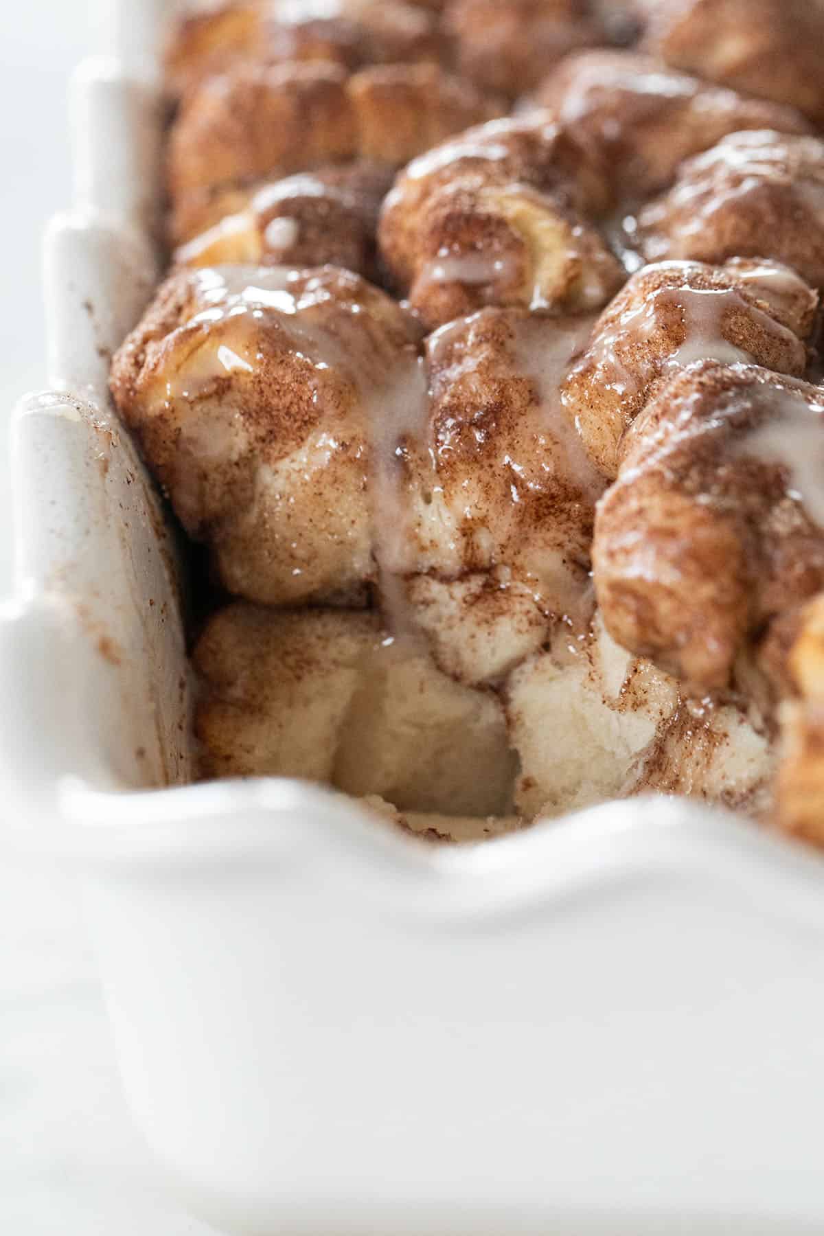how to make monkey bread recipe - cinnamon sugar, bundt pan, cooking time, preheated oven, brown sugar, biscuit pieces, pull apart bread