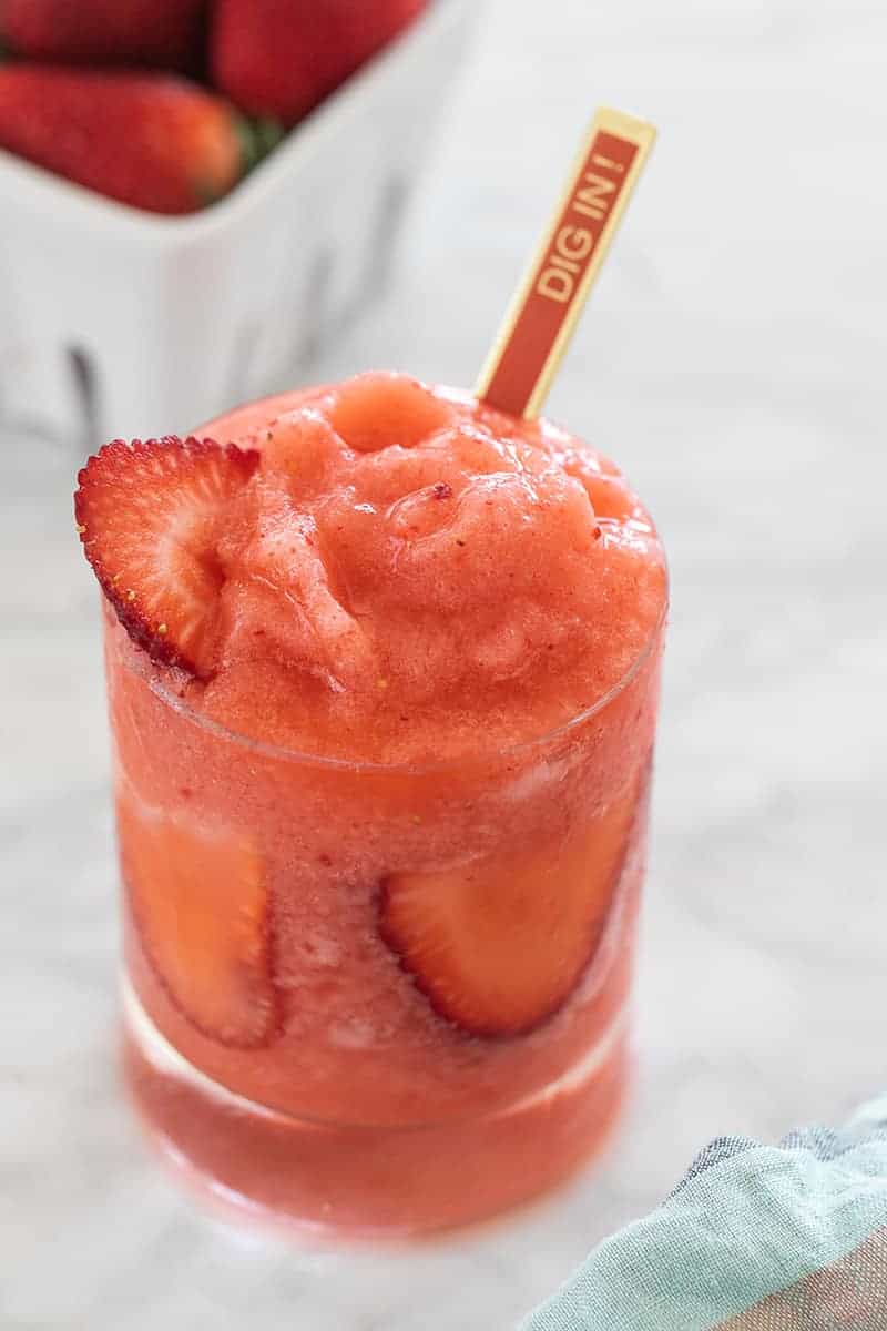 frozen strawberry lemonade with a red spoon 