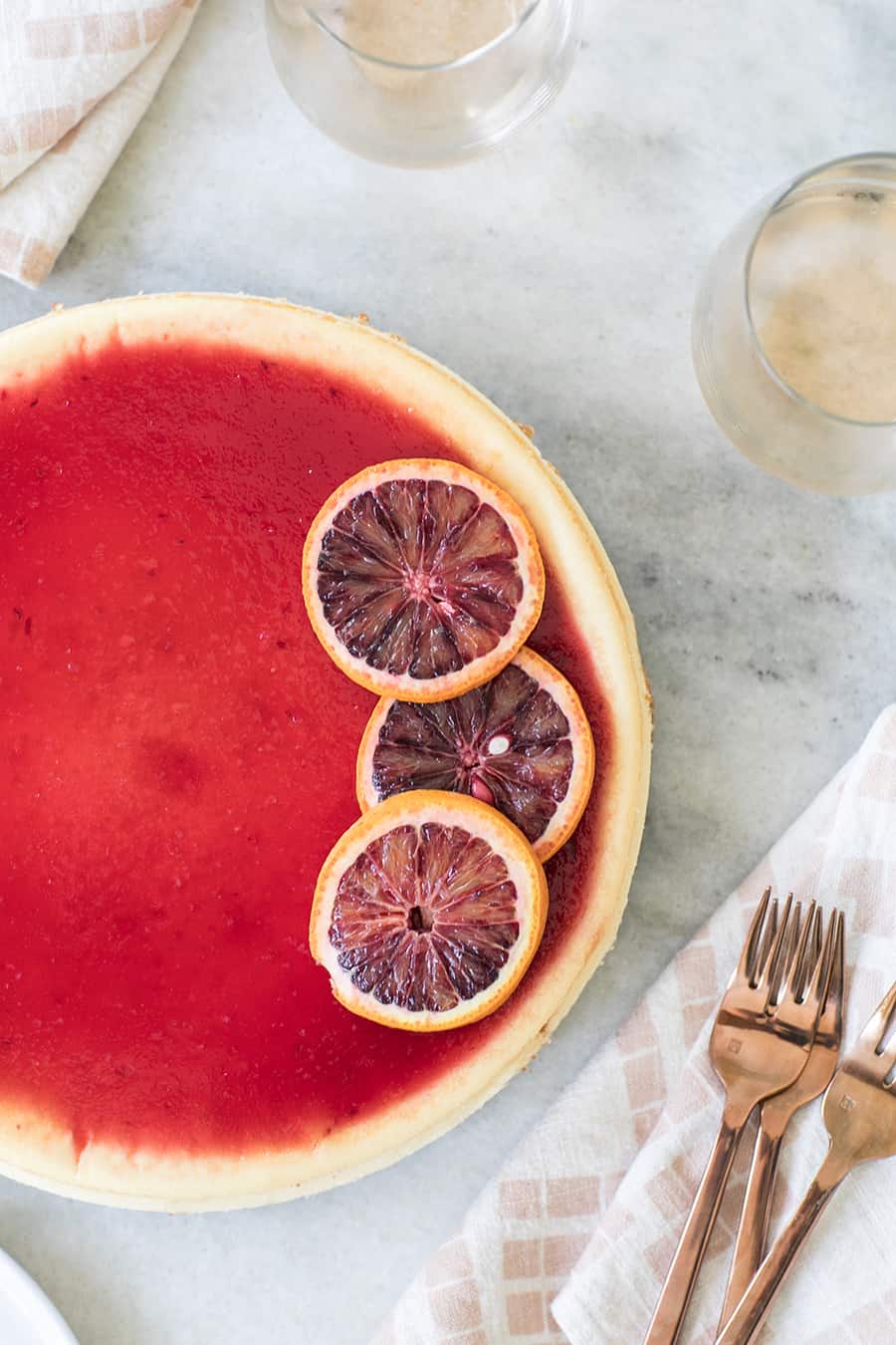 Blood orange cheese cake on a marble table.