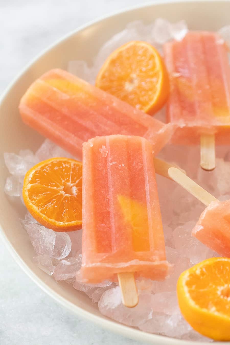 Homemade popsicles using vodka, grapefruit juice and orange.